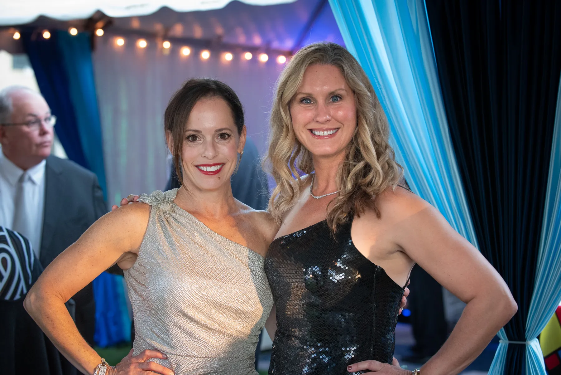 2 women in party dress.